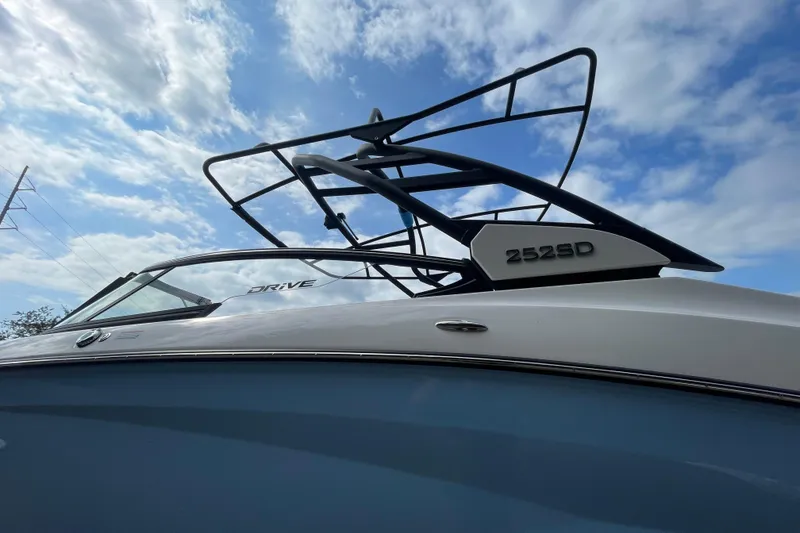 Slide: The Image of 2026 Yamaha Boats 252SD against a cloudy blue sky. - 2