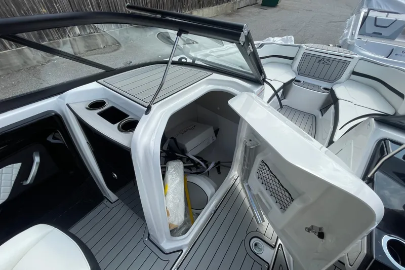 Slide: The Image of 2026 Yamaha Boats 252SD interior with open storage compartment and seating area. - 20