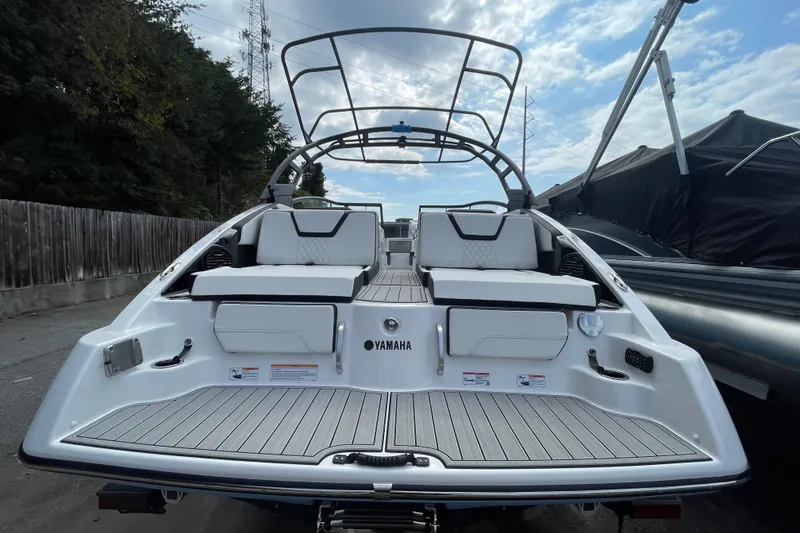 Slide: The Image of 2026 Yamaha Boats 252SD rear view, showcasing sleek design and spacious seating. - 25
