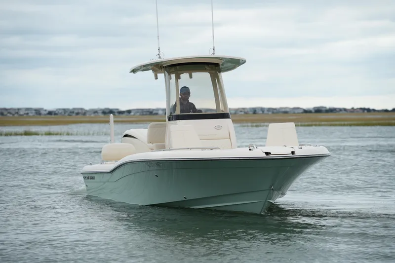 Slide: The Image of 2025 Grady-White 251 Coastal Explorer boat cruising on calm waters. - 10