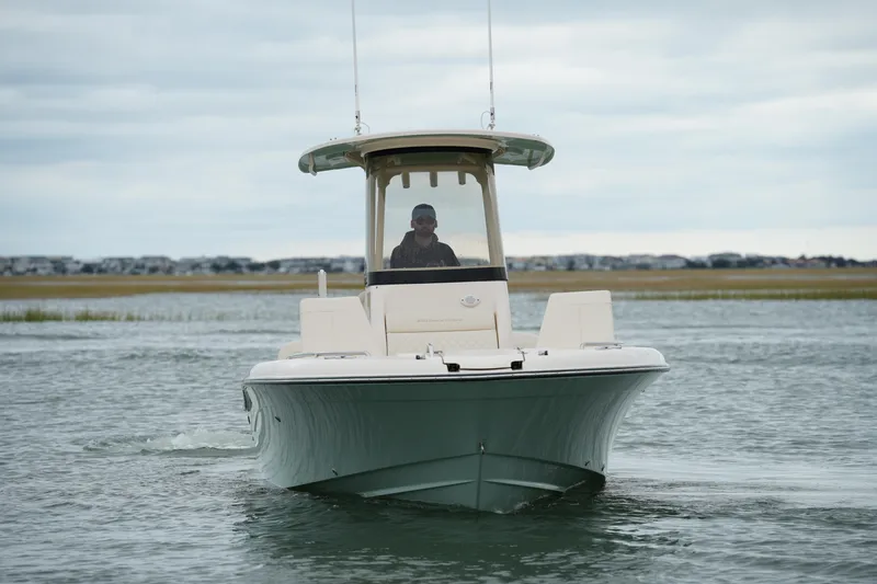 Slide: The Image of 2025 Grady-White 251 Coastal Explorer boat navigating calm waters. - 11