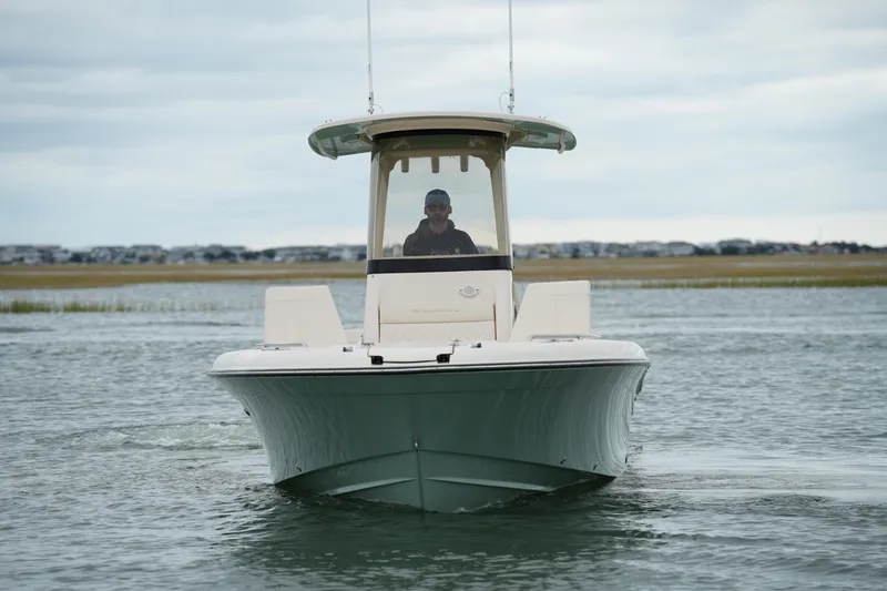 Slide: The Image of 2025 Grady-White 251 Coastal Explorer boat navigating calm waters. - 12