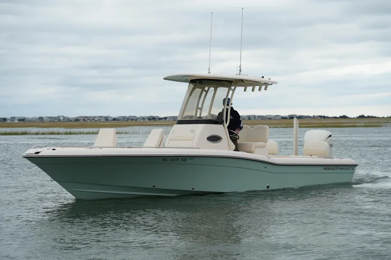 Slide: The Image of 2025 Grady-White 251 Coastal Explorer boat cruising on calm waters. - 14