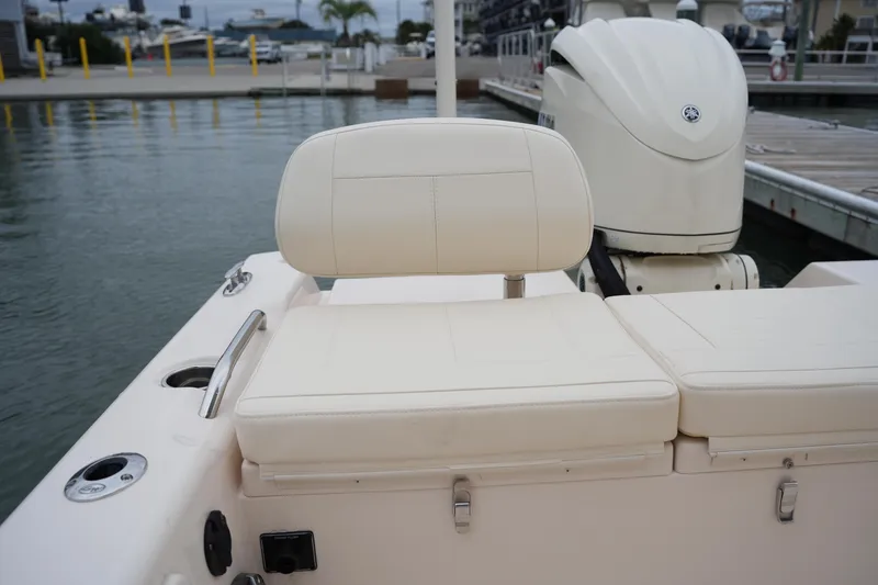 Slide: The Image of 2025 Grady-White 251 Coastal Explorer boat interior with cushioned seating and outboard motor. - 16