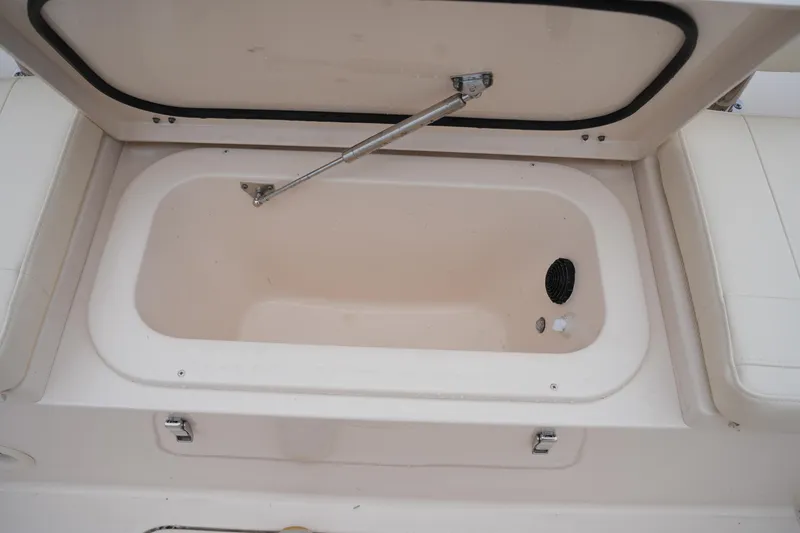Slide: The Image of 2025 Grady-White 251 Coastal Explorer boat storage compartment open, showcasing interior features. - 19