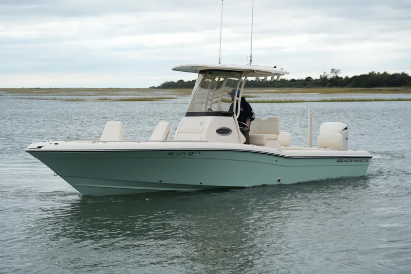 Slide: The Image of 2025 Grady-White 251 Coastal Explorer boat on calm water, overcast sky. - 2