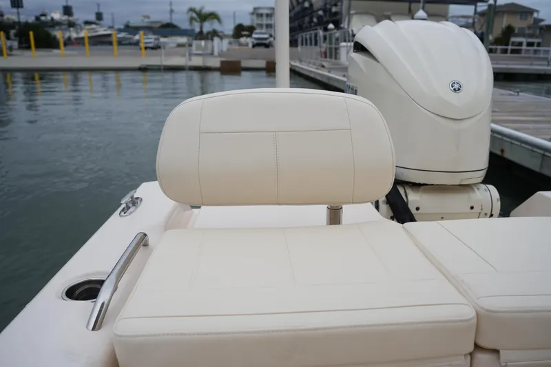 Slide: The Image of 2025 Grady-White 251 Coastal Explorer boat seat and engine at dockside. - 20
