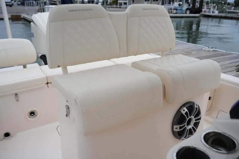Slide: The Image of 2025 Grady-White 251 Coastal Explorer boat seats with quilted upholstery and speaker detail. - 23