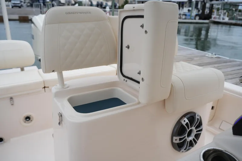 Slide: The Image of 2025 Grady-White 251 Coastal Explorer boat interior with open storage compartment and speaker. - 24