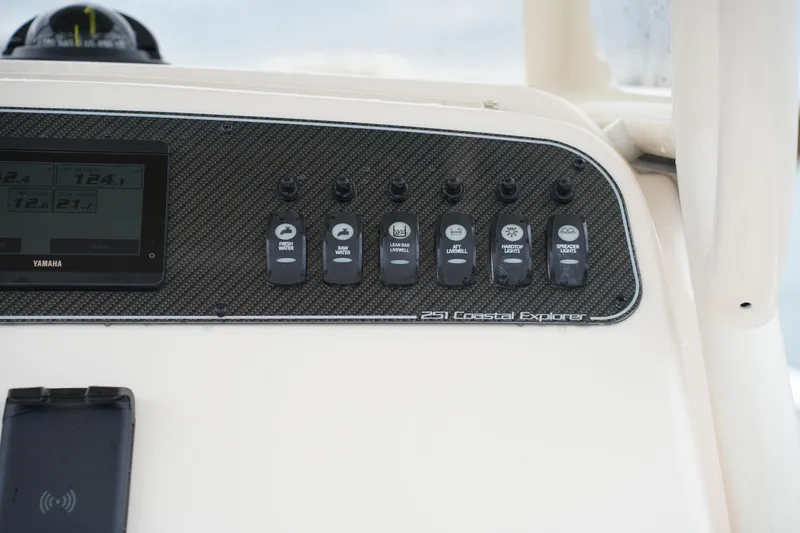 Slide: The Image of Control panel of 2025 Grady-White 251 Coastal Explorer boat with switches and display. - 29