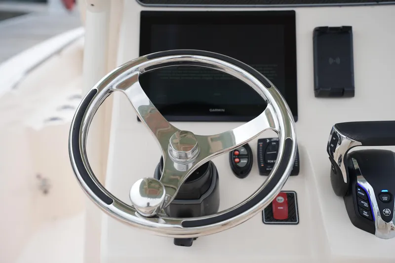 Slide: The Image of Steering wheel and controls of 2025 Grady-White 251 Coastal Explorer boat. - 31