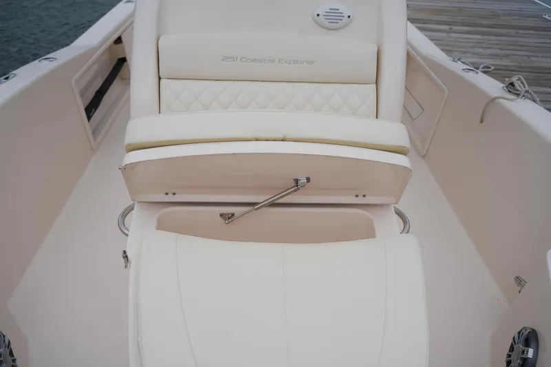 Slide: The Image of 2025 Grady-White 251 Coastal Explorer boat interior with cushioned seating and storage. - 36