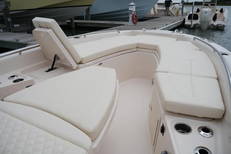 Slide: The Image of 2025 Grady-White 251 Coastal Explorer boat with luxurious seating and cup holders at the dock. - 38