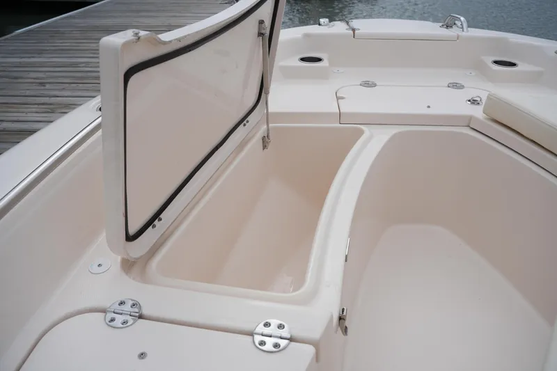 Slide: The Image of 2025 Grady-White 251 Coastal Explorer boat storage compartment open by the dock. - 39