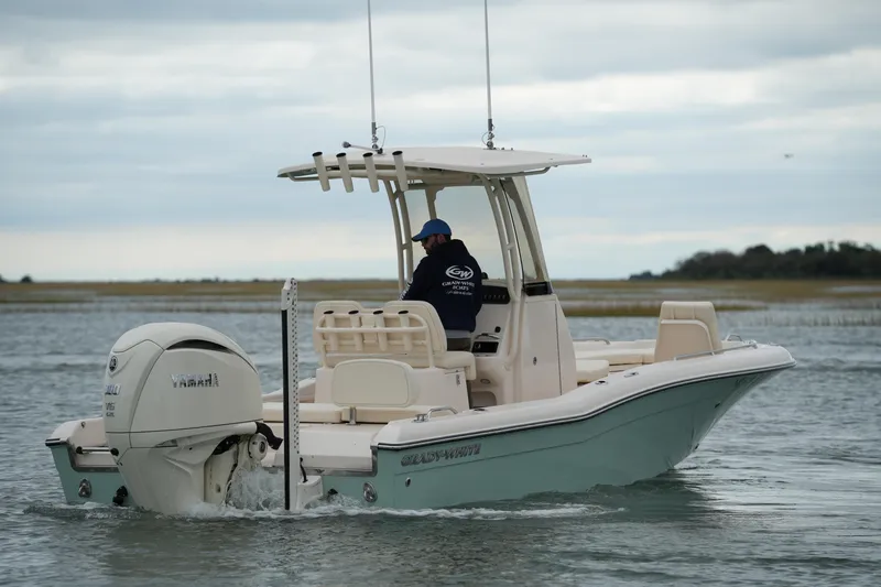 Slide: The Image of 2025 Grady-White 251 Coastal Explorer boat cruising on calm waters. - 4