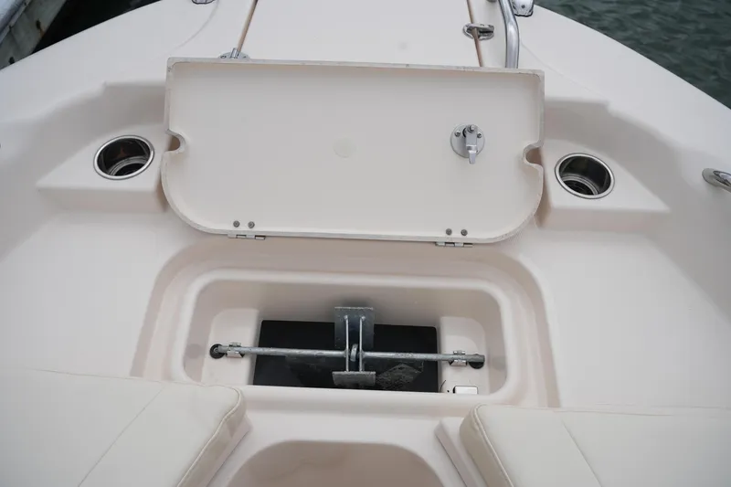 Slide: The Image of 2025 Grady-White 251 Coastal Explorer boat anchor storage compartment, open lid view. - 40