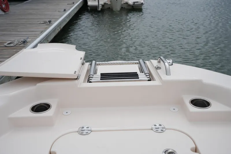 Slide: The Image of 2025 Grady-White 251 Coastal Explorer boat with swim platform and ladder at dock. - 41