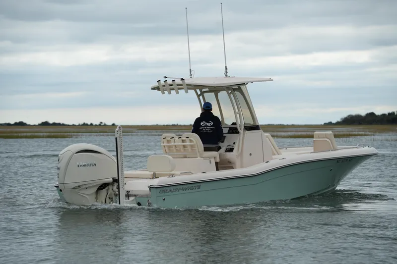 Slide: The Image of 2025 Grady-White 251 Coastal Explorer boat cruising on calm waters. - 5