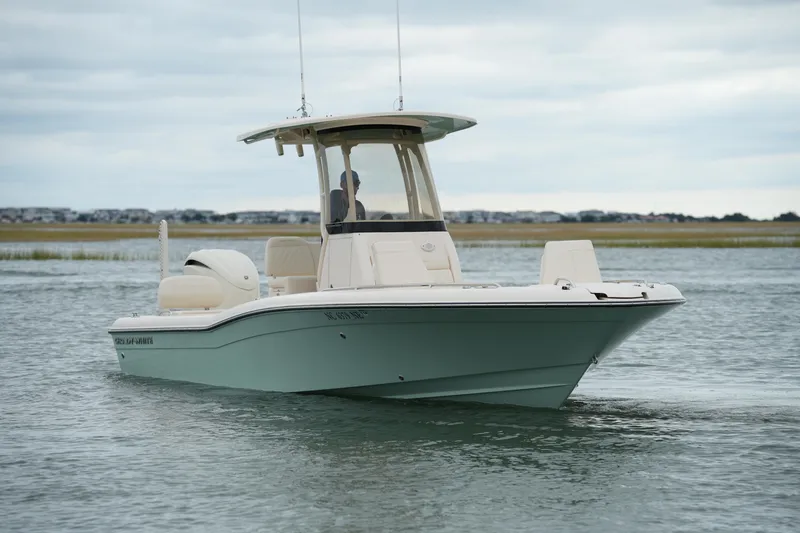 Slide: The Image of 2025 Grady-White 251 Coastal Explorer boat on calm water, overcast sky. - 9