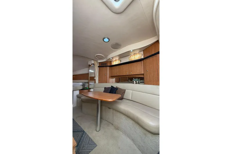 Slide: The Image of Interior of 2006 Sea Ray 340 Sundancer yacht with elegant seating and wooden cabinetry. - 15