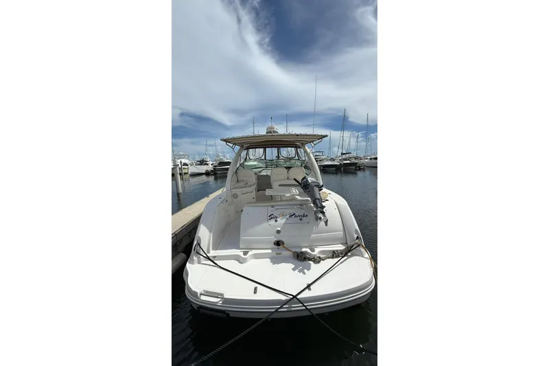 Slide: The Image of 2006 Sea Ray 340 Sundancer docked at marina under blue sky. - 2