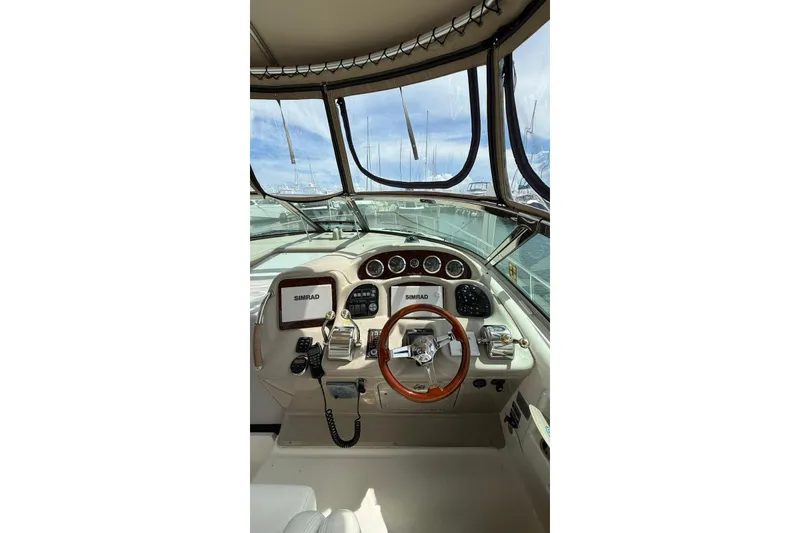 Slide: The Image of 2006 Sea Ray 340 Sundancer helm with Simrad navigation system and wooden steering wheel. - 7