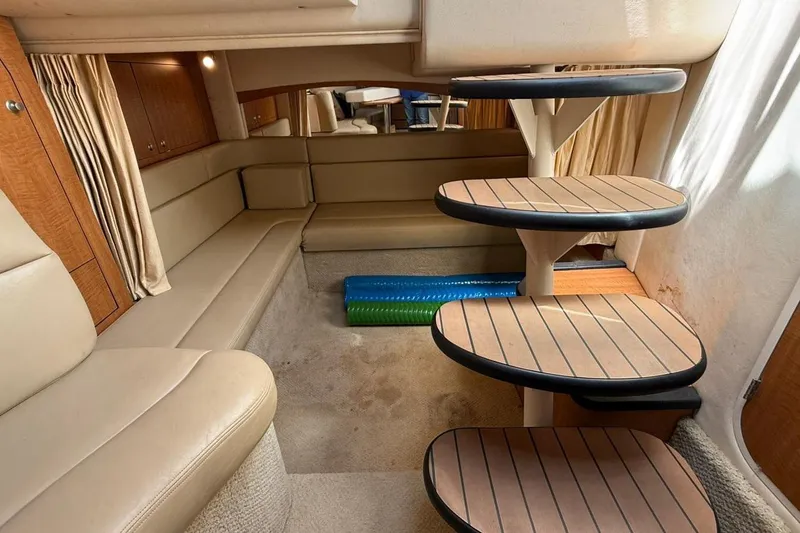 Slide: The Image of Interior of 2006 Sea Ray 340 Sundancer yacht with beige seating and wooden steps. - 8