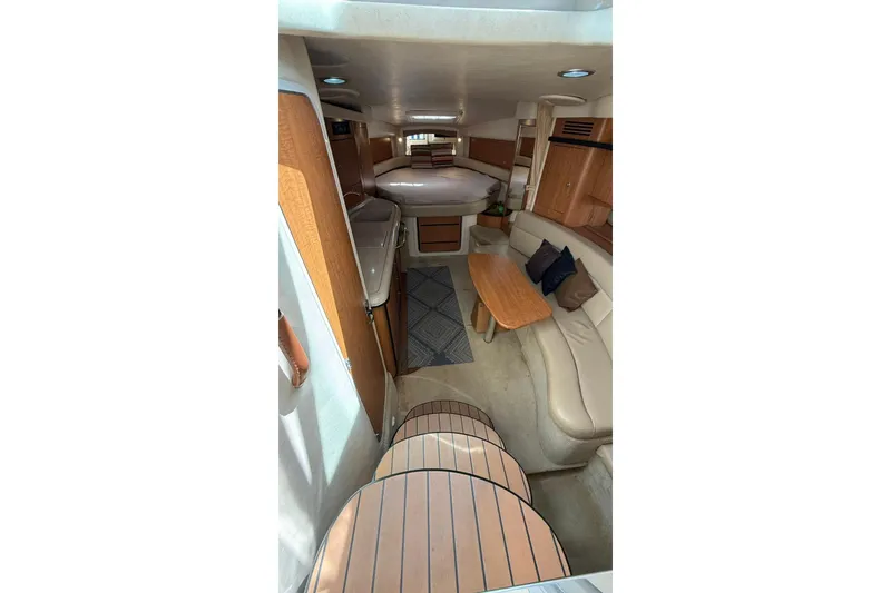 Slide: The Image of Interior of 2006 Sea Ray 340 Sundancer yacht with cozy seating and wooden accents. - 9