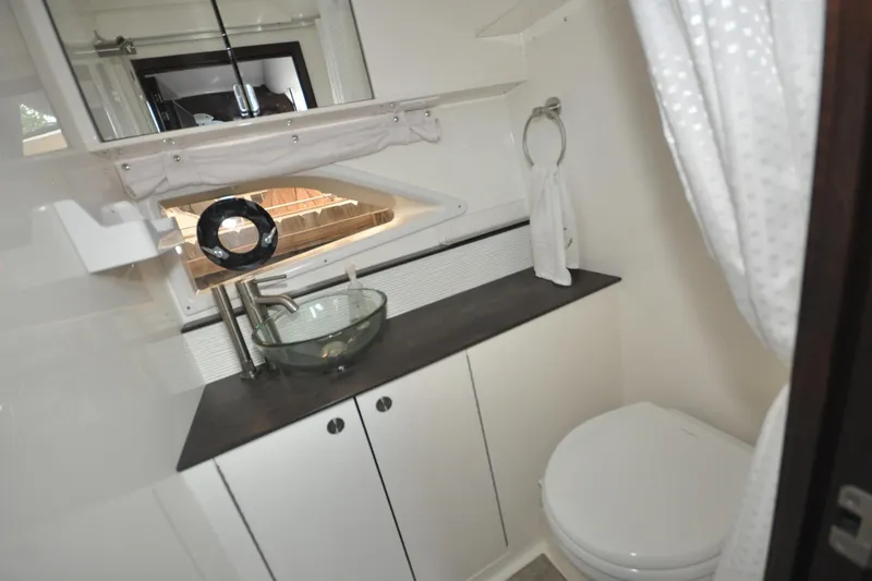Slide: The Image of 2020 Sea Ray Sundancer 320 bathroom with modern sink and toilet. - 15