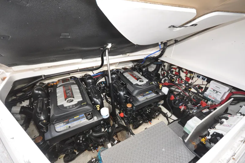 Slide: The Image of Engine compartment of 2020 Sea Ray Sundancer 320, featuring dual engines and wiring. - 18
