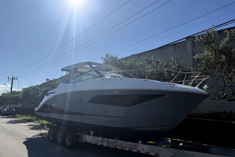 Slide: The Image of 2020 Sea Ray Sundancer 320 boat on trailer under bright sunlight. - 3