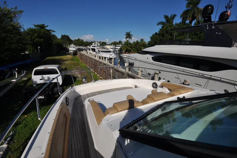 Slide: The Image of 2020 Sea Ray Sundancer 320 docked, surrounded by yachts and lush greenery. - 4