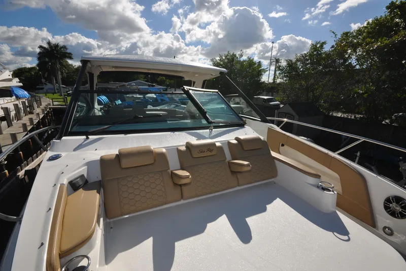 Slide: The Image of 2020 Sea Ray Sundancer 320 boat with spacious deck and luxurious seating under a sunny sky. - 5