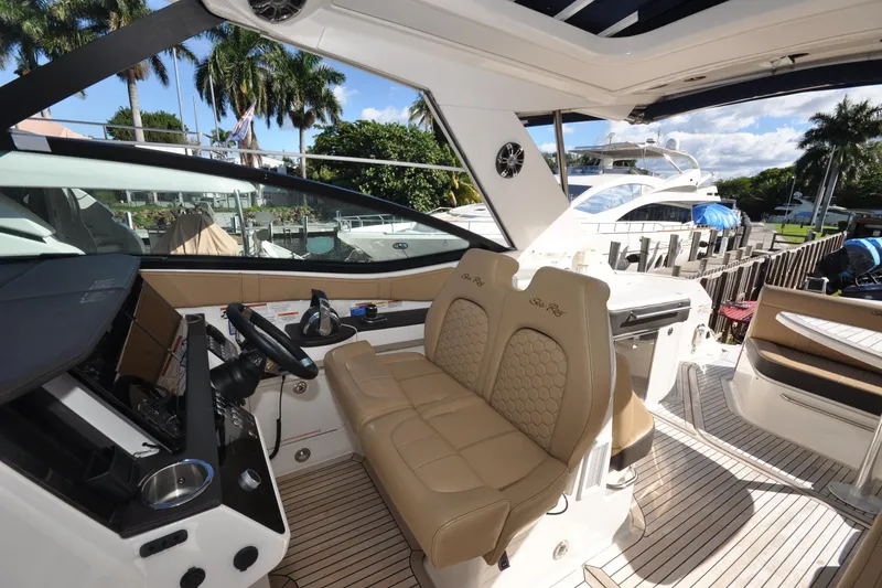 Slide: The Image of Interior view of 2020 Sea Ray Sundancer 320 yacht with luxurious seating and modern dashboard. - 7