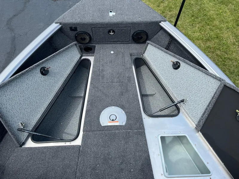Slide: The Image of 2026 Lund 1875 Impact XS Sport boat interior with open storage compartments. - 12