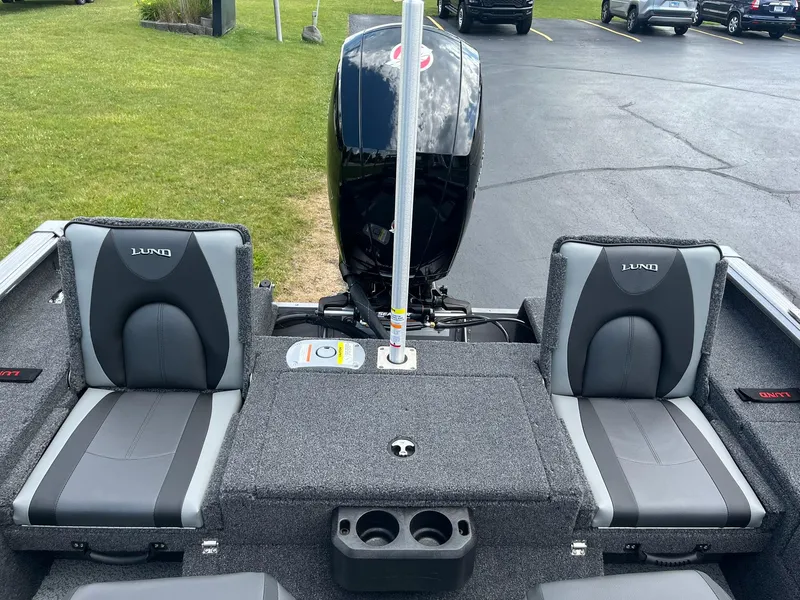 Slide: The Image of 2026 Lund 1875 Impact XS Sport boat interior with dual seats and motor. - 14