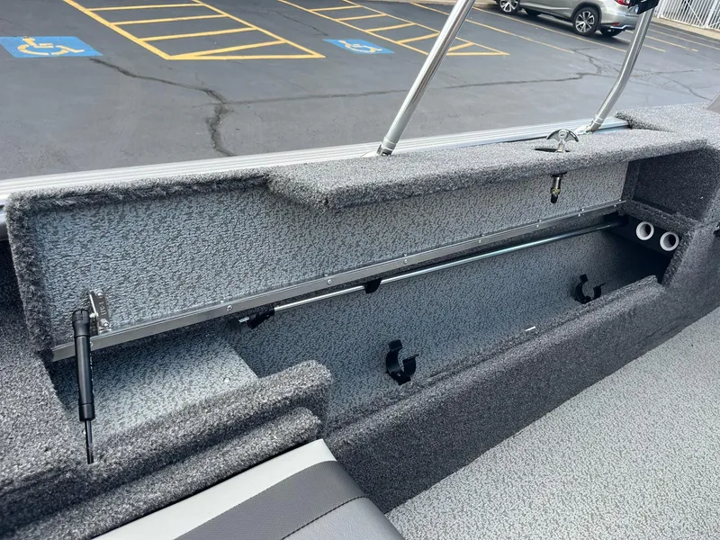Slide: The Image of Interior storage compartment of 2026 Lund 1875 Impact XS Sport boat, open and empty. - 18