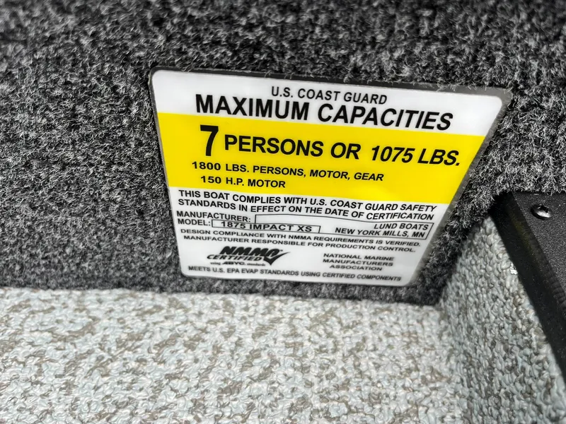 Slide: The Image of Capacity label on 2026 Lund 1875 Impact XS Sport boat, max 7 persons or 1075 lbs. - 25