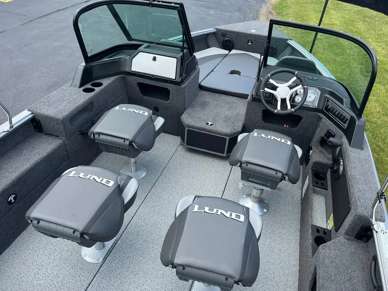 Slide: The Image of 2026 Lund 1875 Impact XS Sport boat interior with four seats and steering console. - 6