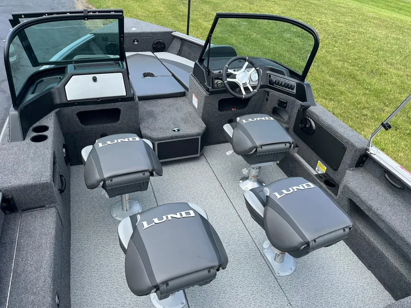 Slide: The Image of 2026 Lund 1875 Impact XS Sport boat interior with four seats and steering console. - 7