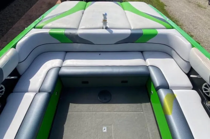 Slide: The Image of 2011 Moomba Mobius LSV boat interior with green and gray seating. - 4