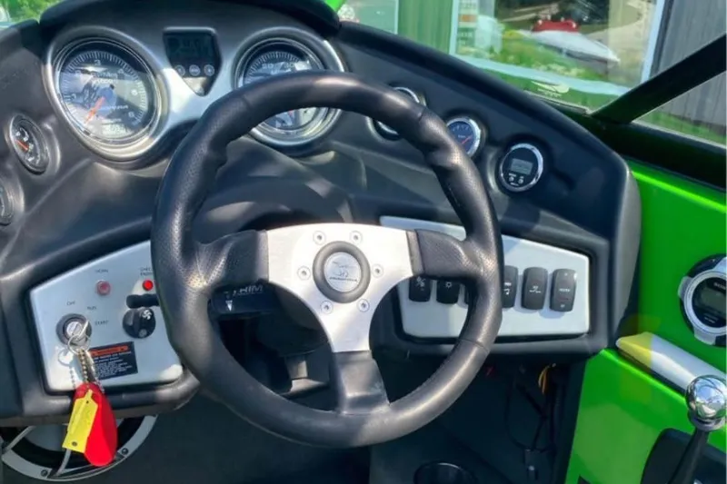 Slide: The Image of 2011 Moomba Mobius LSV dashboard with steering wheel and control panel. - 7