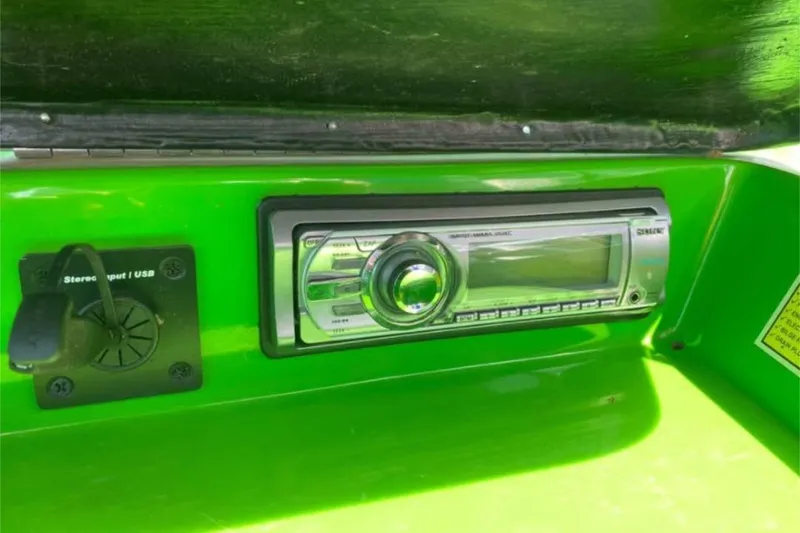 Slide: The Image of 2011 Moomba Mobius LSV stereo system with USB input on green dashboard. - 9