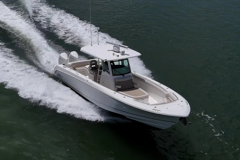 Slide: The Image of 2020 Boston Whaler 330 Outrage cruising on open water, showcasing sleek design and powerful performance. - 12