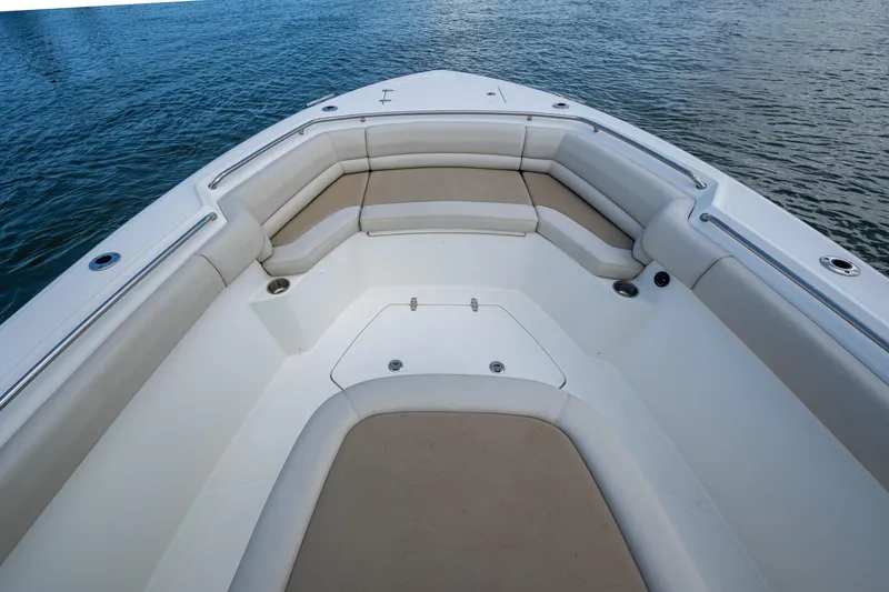 Slide: The Image of 2020 Boston Whaler 330 Outrage boat with spacious seating area on calm water. - 17