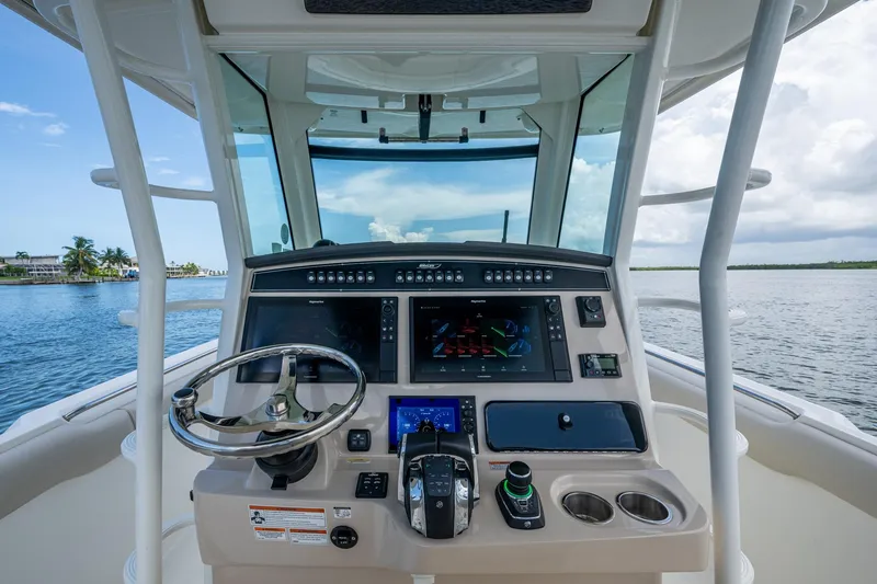 Slide: The Image of 2020 Boston Whaler 330 Outrage helm with advanced navigation system on open water. - 24