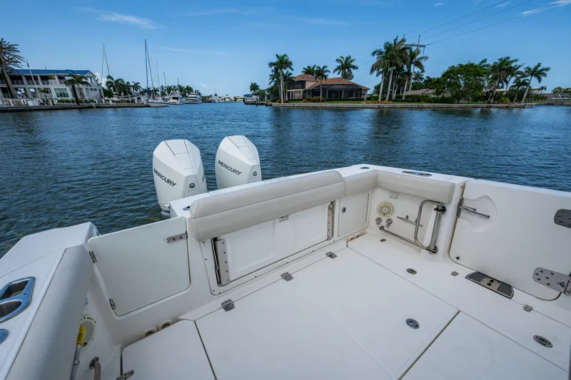 Slide: The Image of 2020 Boston Whaler 330 Outrage boat with twin Mercury engines on a scenic waterway. - 27
