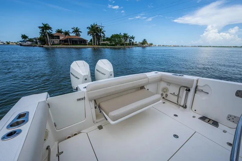 Slide: The Image of 2020 Boston Whaler 330 Outrage boat with dual Mercury engines on calm water. - 28