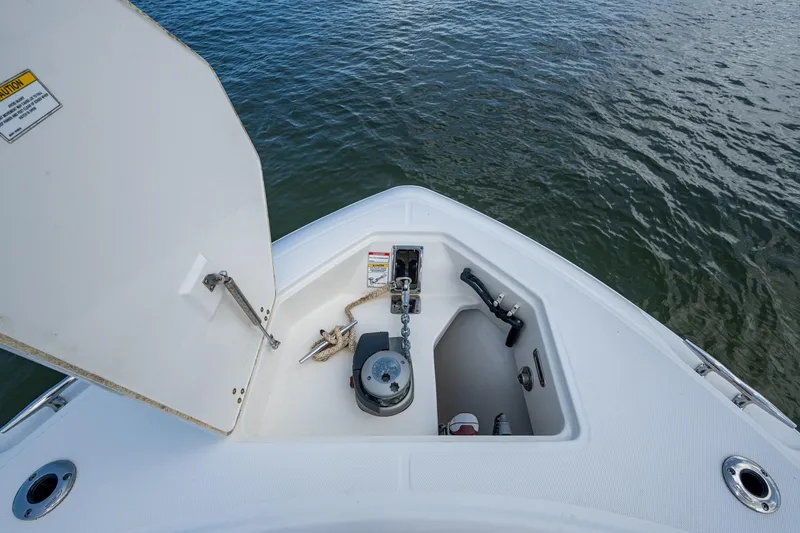 Slide: The Image of 2020 Boston Whaler 330 Outrage anchor storage compartment on calm water. - 34