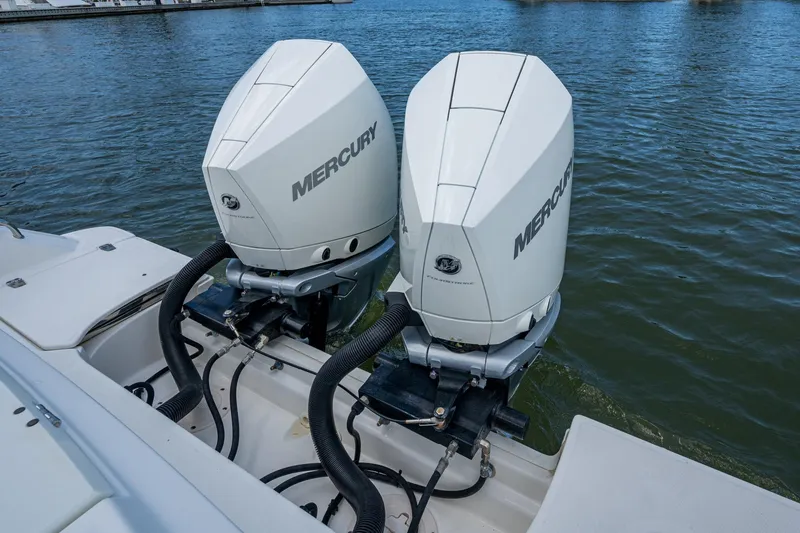 Slide: The Image of Twin Mercury outboard engines on a 2020 Boston Whaler 330 Outrage boat. - 37